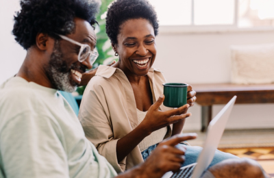 Happy retired couple on laptop